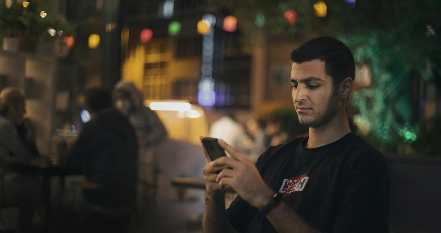 Coffee drinker discovering roasters on their phone in a cafe
